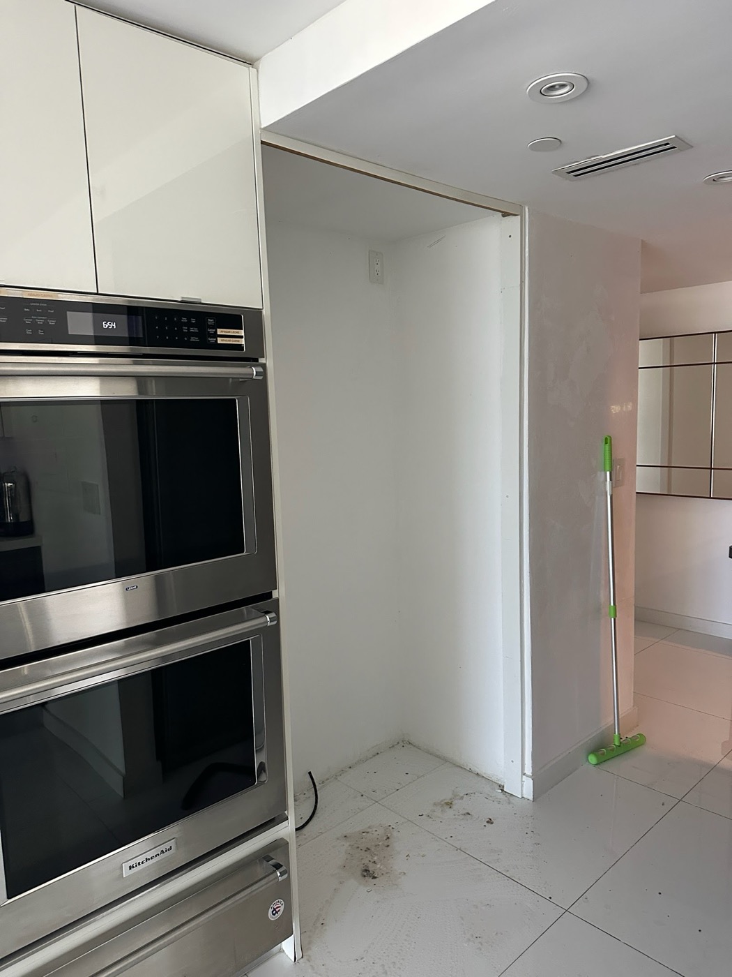 After: Same kitchen floor cleared and cleaned, refrigerator removed