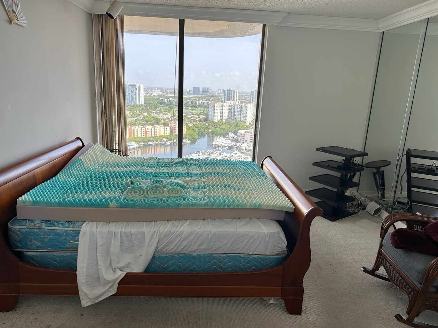 High-rise condo bedroom with mattress and personal items before junk removal
