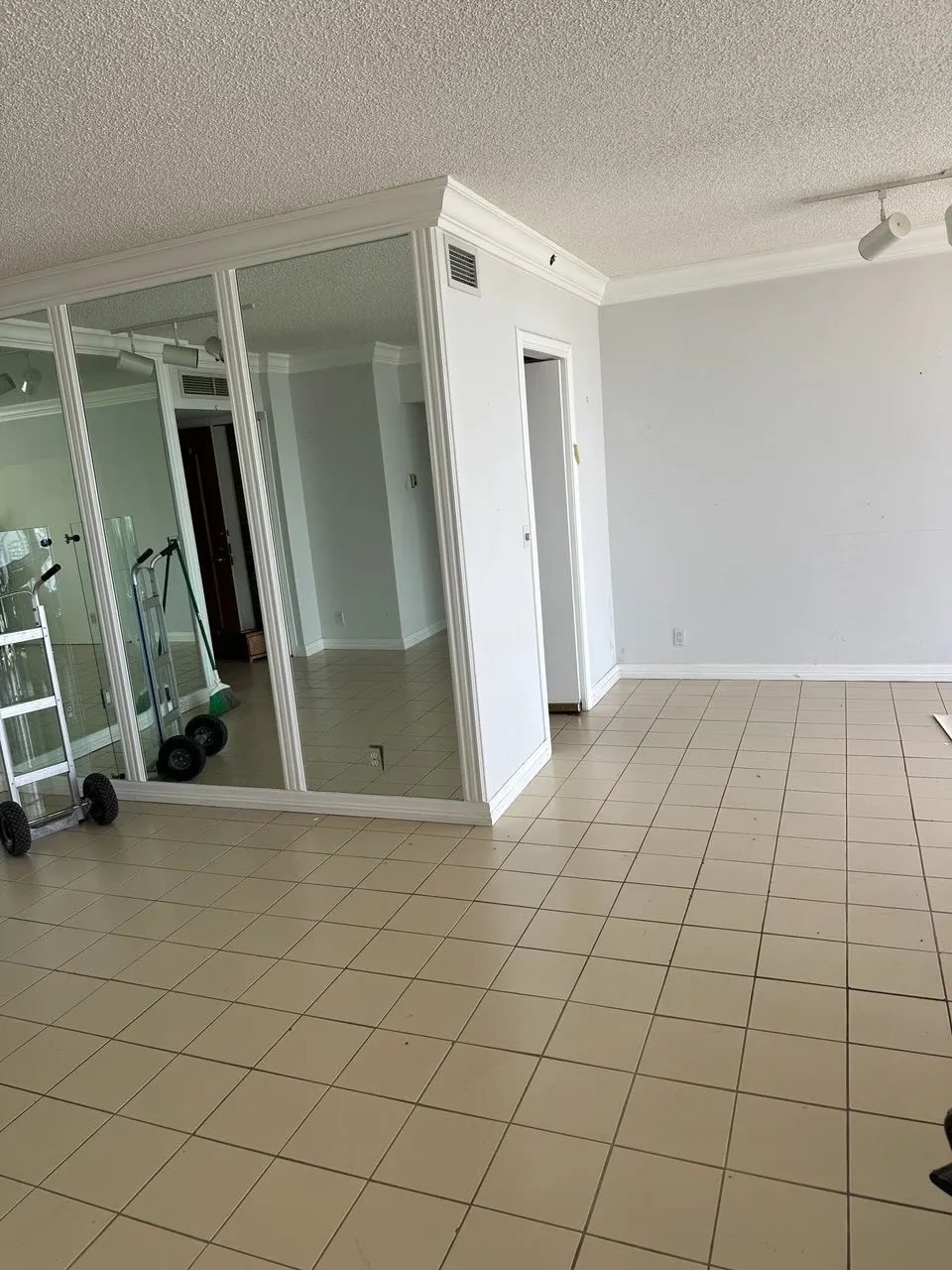 Bathroom and laundry area cleared of clutter, tiles and fixtures visible after junk removal