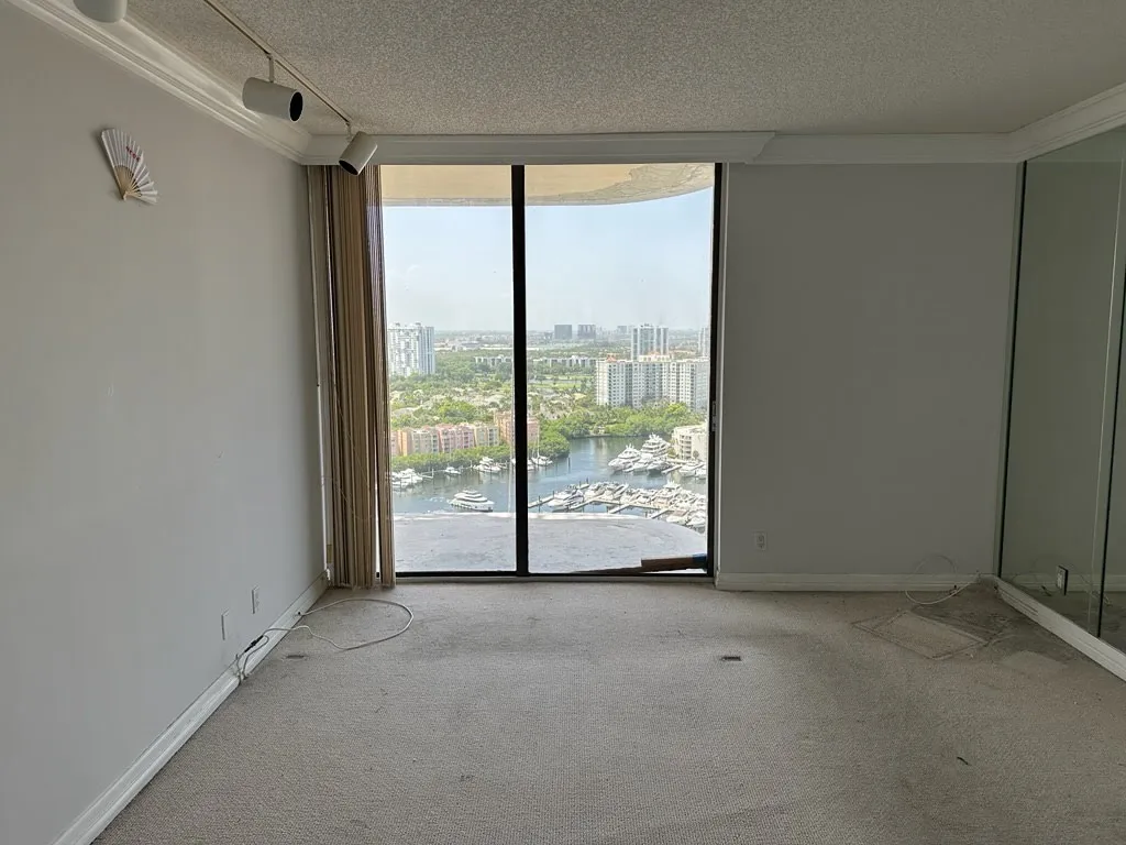 After: Empty high-rise apartment, completely cleared with Miami skyline view