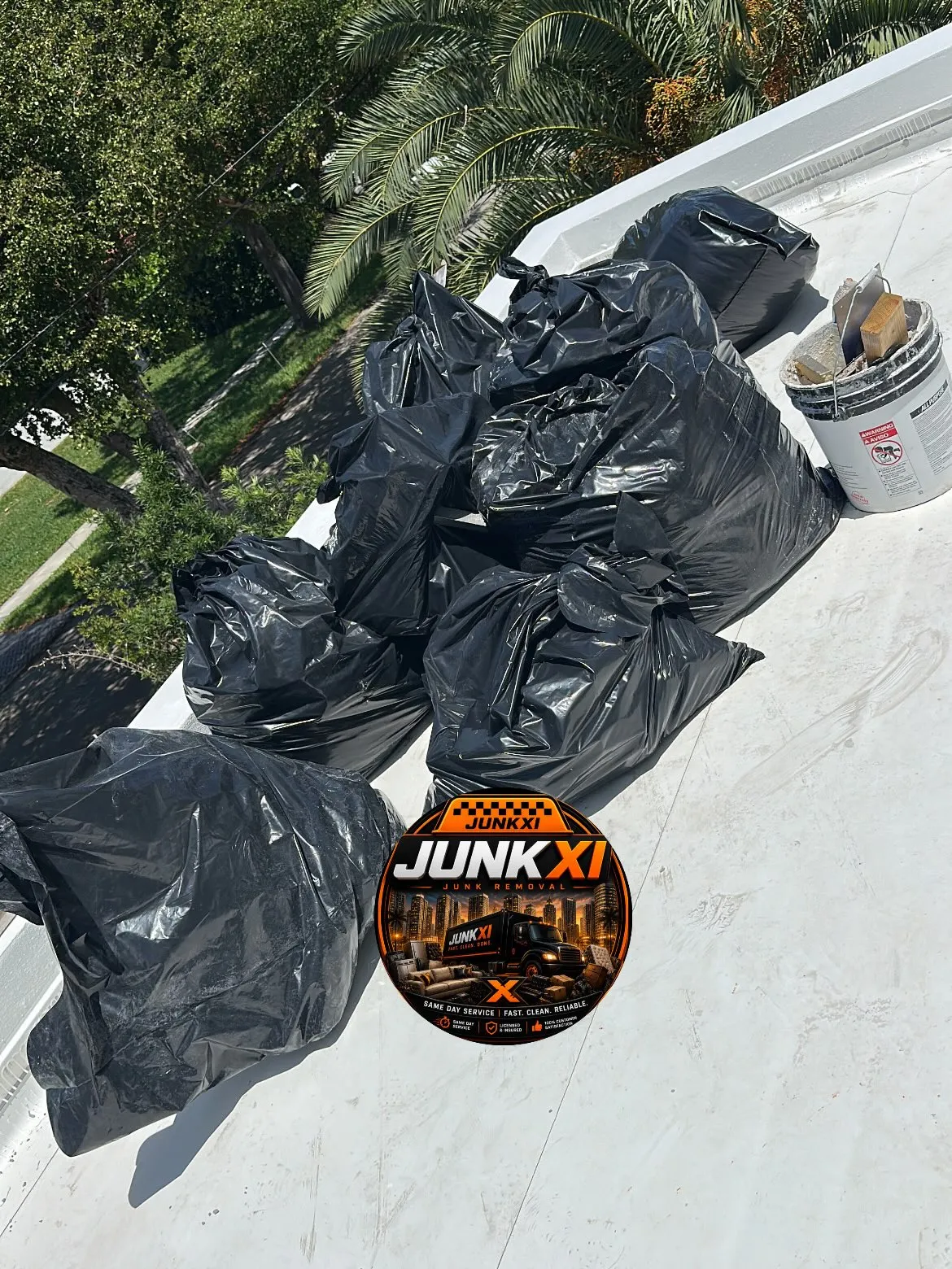 Junk-Xi truck fully loaded with bagged junk and debris ready for disposal, Miami service